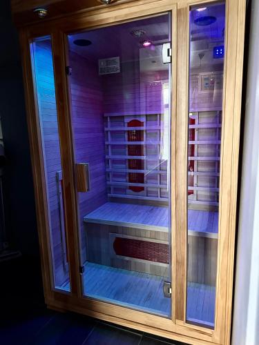 a glass cabinet with a bed inside of it at La suite 44 in Le Locle