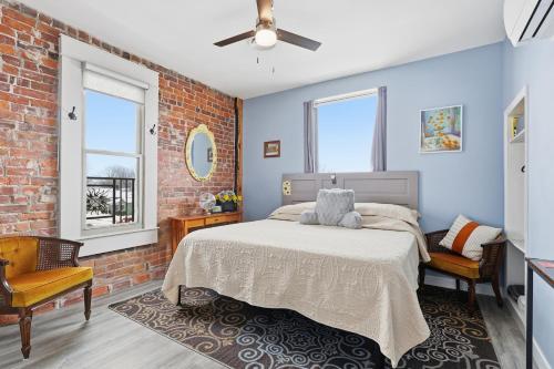 a bedroom with a bed and a brick wall at The Tiptonian in Tipton