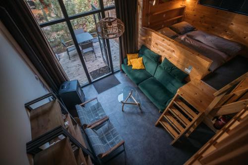 an overhead view of a living room with a green couch at Holiday Home Maridu Tiny Cube in Arnhem