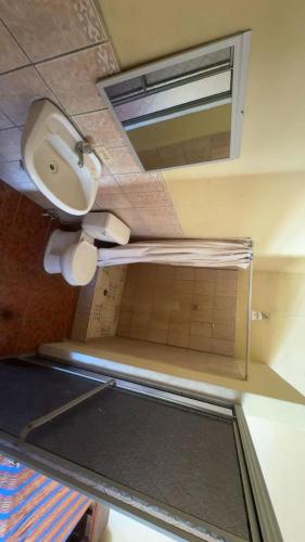 a bathroom with a sink and a toilet and a mirror at Accommodation in Copán Ruinas #7 in Copán Ruinas