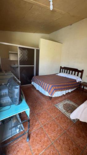 a bedroom with a bed and a tv in it at Accommodation in Copán Ruinas #7 in Copán Ruinas