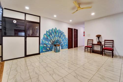a living room with a ceiling fan and a table at Collection O Calvathy Road Near Fort Kochi in Cochin