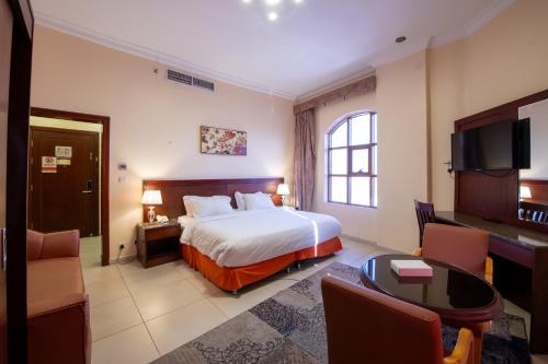 a hotel room with a bed and a table at Al Ayniah Hotel in Medina