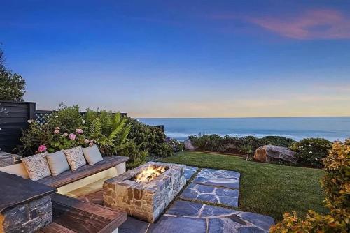 a backyard with a couch and a fire pit at Salty Sunrise in Aptos