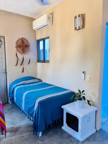 a bedroom with a bed and a tv on a table at Cozy Little Apartment in Sayulita