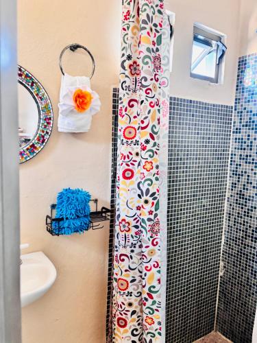 a shower curtain in a bathroom with a sink at Cozy Little Apartment in Sayulita