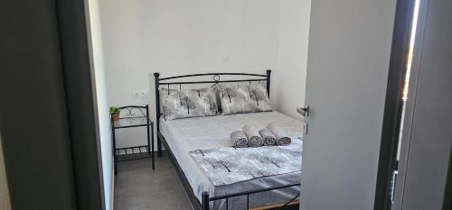 a bedroom with a bed with shoes on it at ΜaryAnn`s house 2 in Livadakia