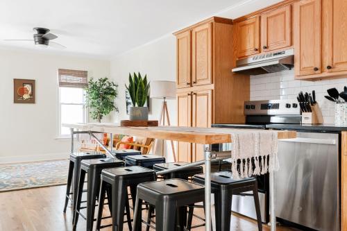 a kitchen with a wooden counter and stools at Newly Renovated Steps to Bars & Restaurants in Charleston