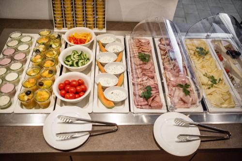 a table with many trays of food on it at AlpenParks Hotel & Apartment Orgler Kaprun in Kaprun