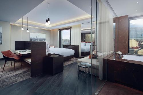 a hotel room with a bed and a desk and a bathroom at Hilton Belgrade in Belgrade