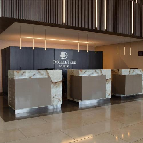 a lobby with marble counter tops in a building at Hilton DoubleTree Bogotá Salitre AR in Bogotá