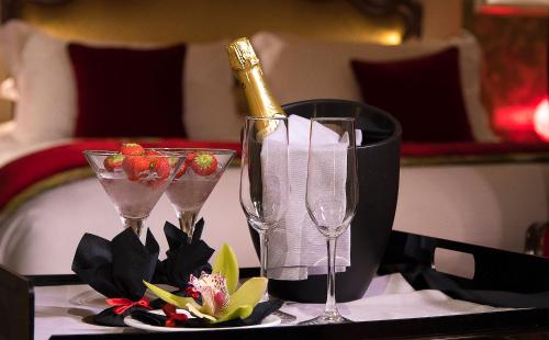 a bottle of champagne and two glasses on a table at Papadopoli Hotel Venezia - MGallery Collection in Venice