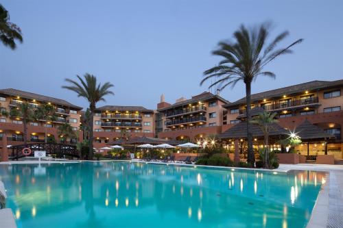 a large swimming pool in front of a hotel at DoubleTree by Hilton Islantilla Beach Golf Resort in Islantilla