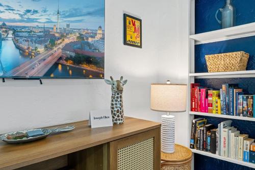 a living room with a tv and a book shelf at Belote Place Bungalow in Jacksonville