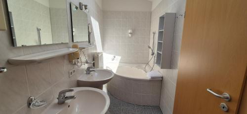 a bathroom with a sink and a toilet and a tub at Bel Sole Badenweiler in Badenweiler