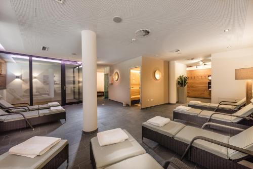 a salon with couches and tables in a room at AlpenParks Hotel & Apartment Orgler Kaprun in Kaprun