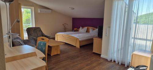 a room with a bedroom with a bed and a window at Bel Sole Badenweiler in Badenweiler