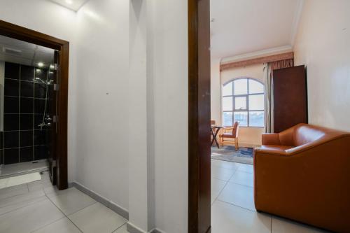 a living room with a chair and a table at Al Ayniah Hotel in Medina