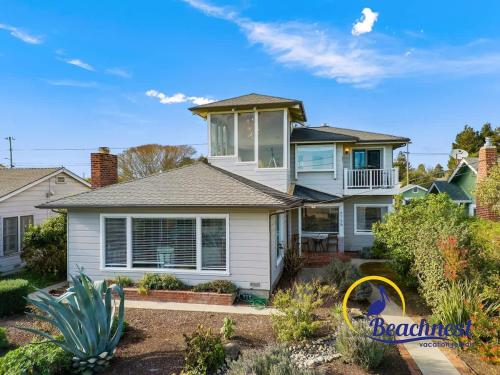 a white house with a garden in front of it at Opal Cliff Overlook in Santa Cruz