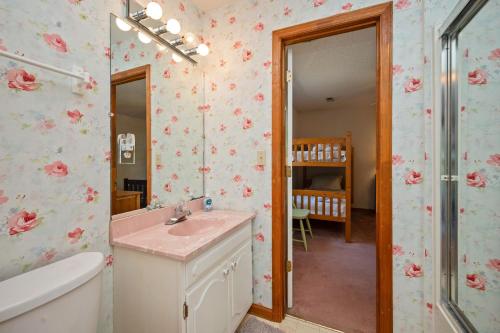 a bathroom with a sink and a mirror at The Rectory by Oak Island Accommodations in Oak Island