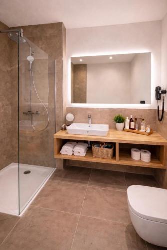 a bathroom with a sink and a shower at Hotel Ks in Bad Fallingbostel