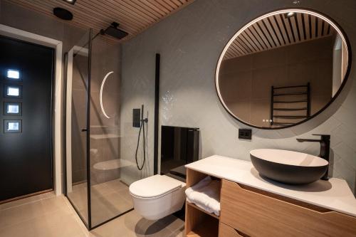 a bathroom with a sink and a mirror at Lyngen North in Rotsund