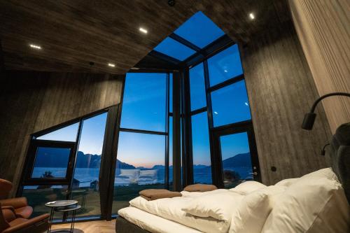 a room with two beds and a large window at Lyngen North in Rotsund