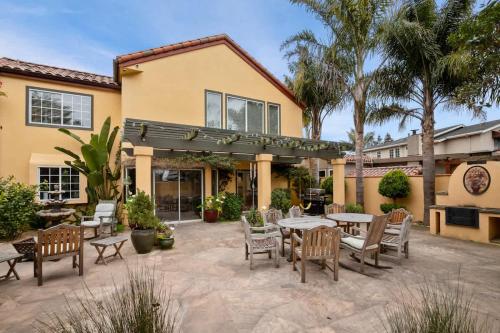 a patio with tables and chairs in front of a house at Acanto Del Mar in Aptos