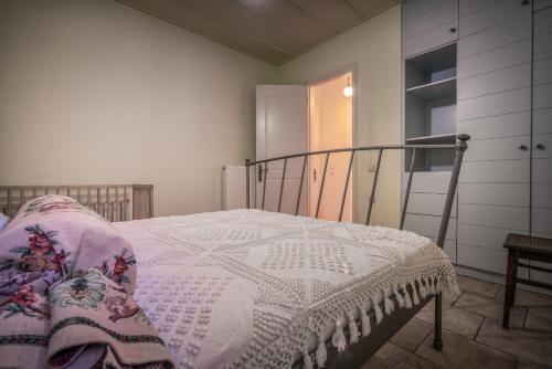 a bedroom with a bed with a blanket on it at Bratis Holiday Home in Kallithea