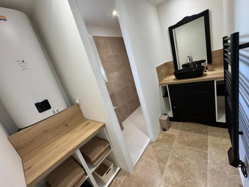 a bathroom with a sink and a mirror at Maison 4 personnes in Saint-Julien
