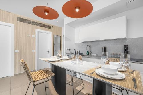 a kitchen with a large island with chairs and tables at Redsearent front Pool and mountain View in Eilat
