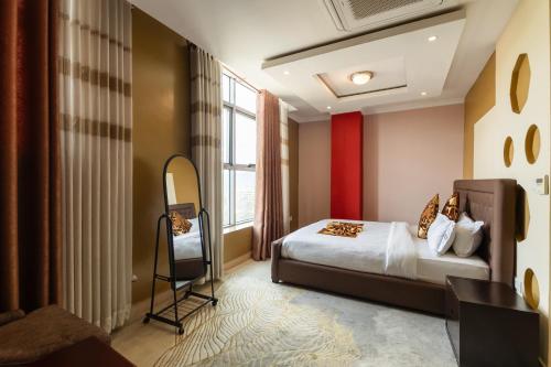 a hotel room with a bed and a mirror at IZA Serene city centre apartments in Kigali
