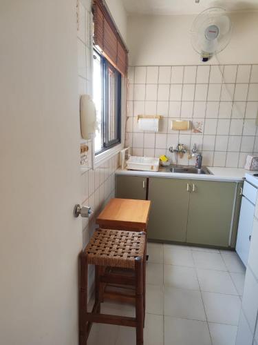 a small kitchen with a table and a sink at Profelia Sea View Apartment in Paralimni