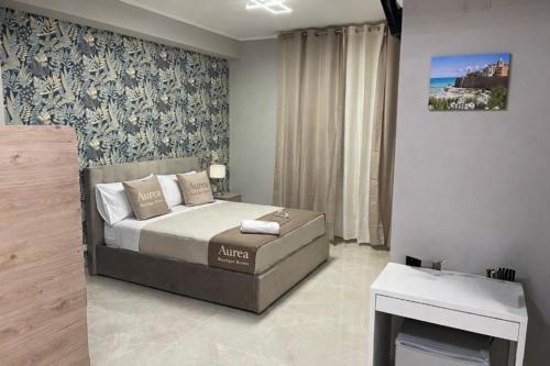 a bedroom with a bed and a table in it at Aurea Boutique Rooms in Termoli