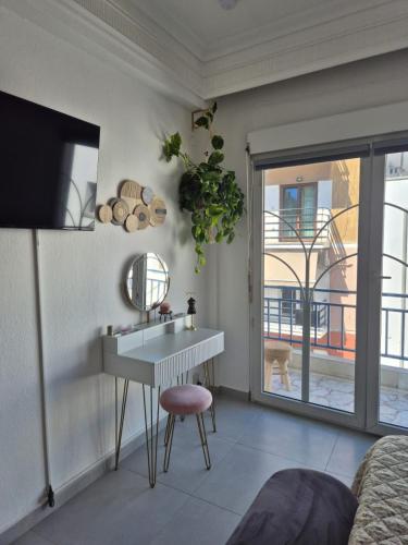 a living room with a sink and a mirror at Mok's House in Kavála