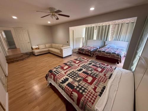 a large bedroom with two beds and a couch at Mountain Hideway in Coarsegold