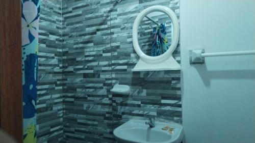 a bathroom with a sink and a mirror at Hospedaje Viento in Paracas