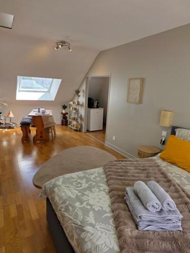 a bedroom with a bed with towels on it at Les appartements du Marché in Dinan