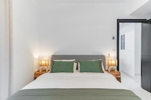 a bedroom with a large bed with two green pillows at Los Naranjos House in Marbella