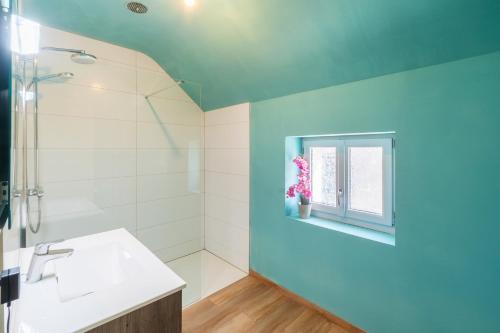a bathroom with a sink and a window at Bienvenue chez Pépère in Nitry