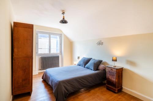 a bedroom with a large bed and a window at Bienvenue chez Pépère in Nitry