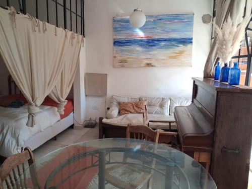 a living room with a couch and a glass table at Loft Junín in Junín