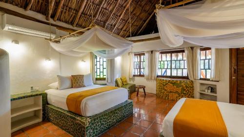 a bedroom with two beds in a room at Zamas Hotel in Tulum