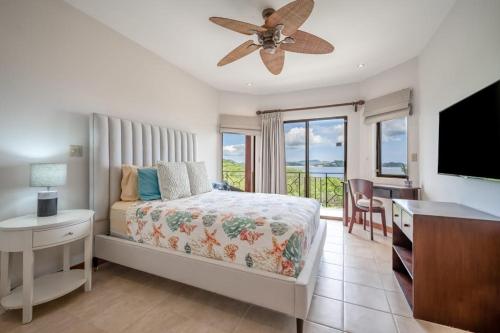 a bedroom with a bed and a ceiling fan at Villas Catalina 7 in Potrero
