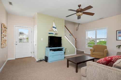 a living room with a tv and a couch at This Is It by Oak Island Accommodations in Oak Island