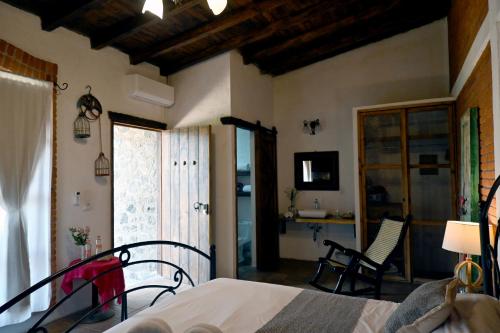 a bedroom with a bed and a window and a desk at Hotel Boutique Rincon Sagrado in Atlixco
