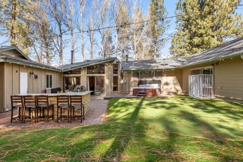 a home with a patio and a yard with grass at Rare Indoor Pool, Game Room & Courts, 5 Blocks to Snow Summit in Big Bear Lake