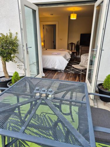a glass table on a balcony with a bed at Brona Dempsey in Birr