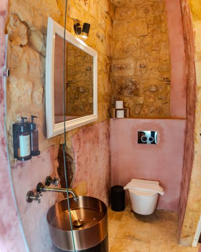 a bathroom with a sink and a toilet at Talbot House by Talbot & Bons in Luqa