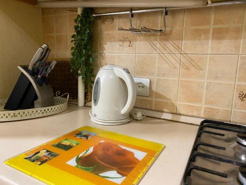 a kitchen counter with a picture on the counter top at One bedroom king size center in Dnipro